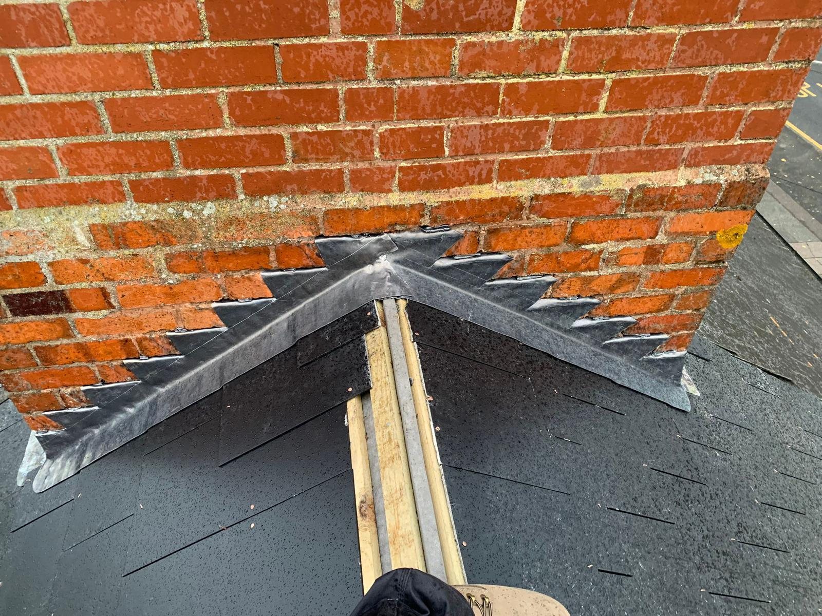 Chimney repair work on a roof